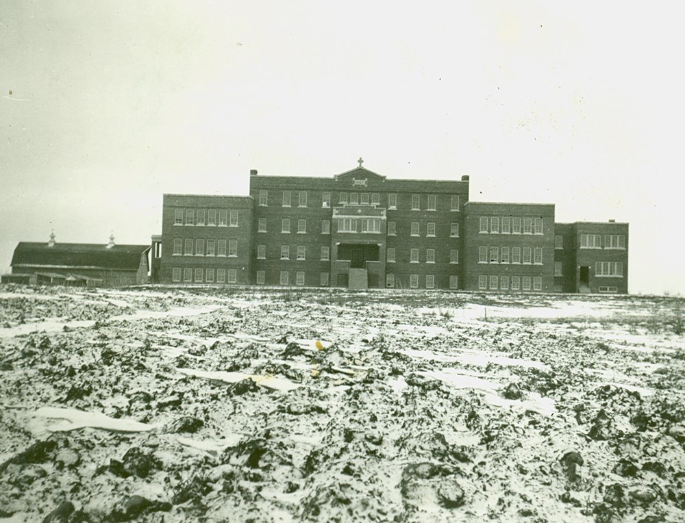 Exterior of Old Sun School, the last window on either side of the fourth floor was for the staff room, and the senior dormitories were in the middle of the floor.  [193-?]. P75-103-S7-188 from the General Synod Archives, Anglican Church of Canada.