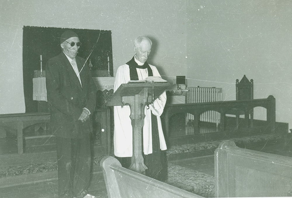 Canon Gibbon Stocken and Chief Paul Little Walker at the front of Old Sun chapel [ca. 1949]. P75-103-S7-197 from The General Synod Archives, Anglican Church of Canada