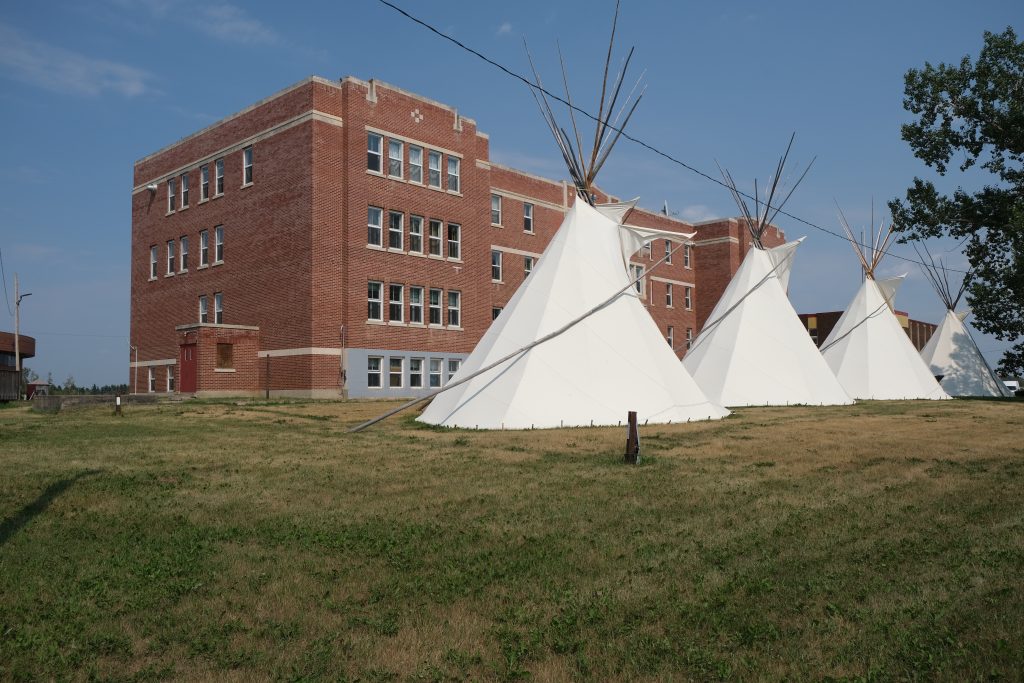 Exterior of Blue Quills with tipis set up, taken during digital capture in August 2021. From Madisen Hvidberg.