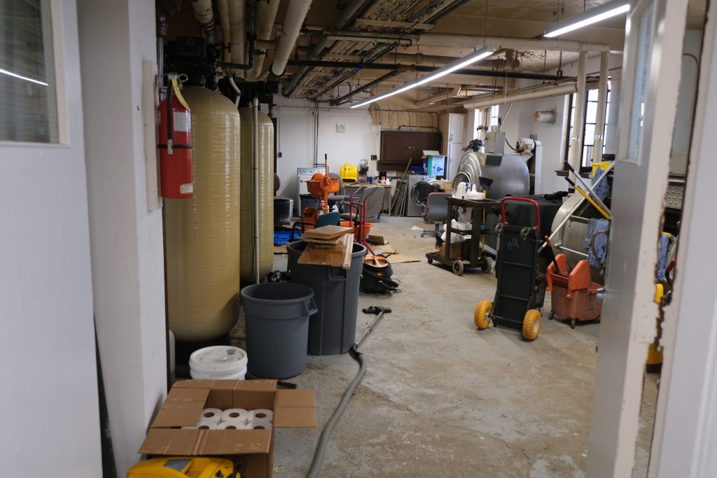 UnBQ utilities room, mostly unchanged from when it was used for the operation of the IRS. Some of the original equipment, such as the hand operated laundry machines remain. Taken during digital documentation, August 2022. From Madisen Hvidberg.