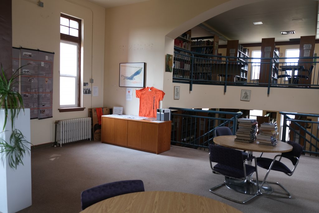 Orange shirt in the UnBQ library, under the archway of the former chapel apse. Taken during project meeting, March 2022. From Madisen Hvidberg.