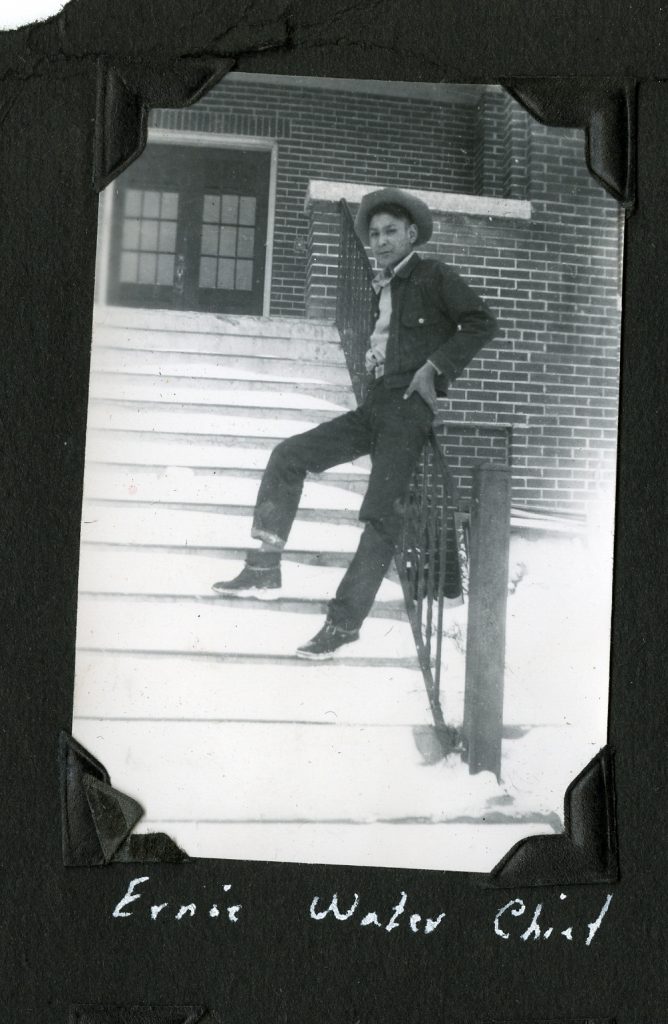 Earnie Water Chief on the front steps of Old Sun IRS, ca. 1952. Photo Source: Shingwauk Residential Schools Centre, Algoma University