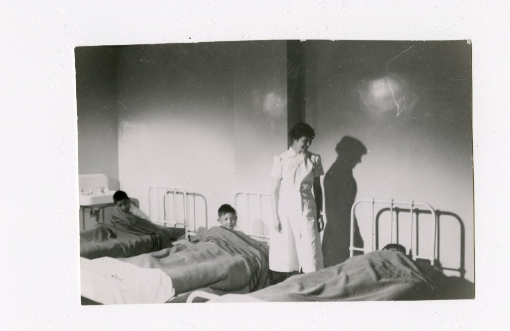 Jr. Boys' Dormitory during the filming of a documentary, with the addition of nicer quilts on the beds. Old Sun IRS, 1952. Photo Source: Shingwauk Residential Schools Centre, Algoma University