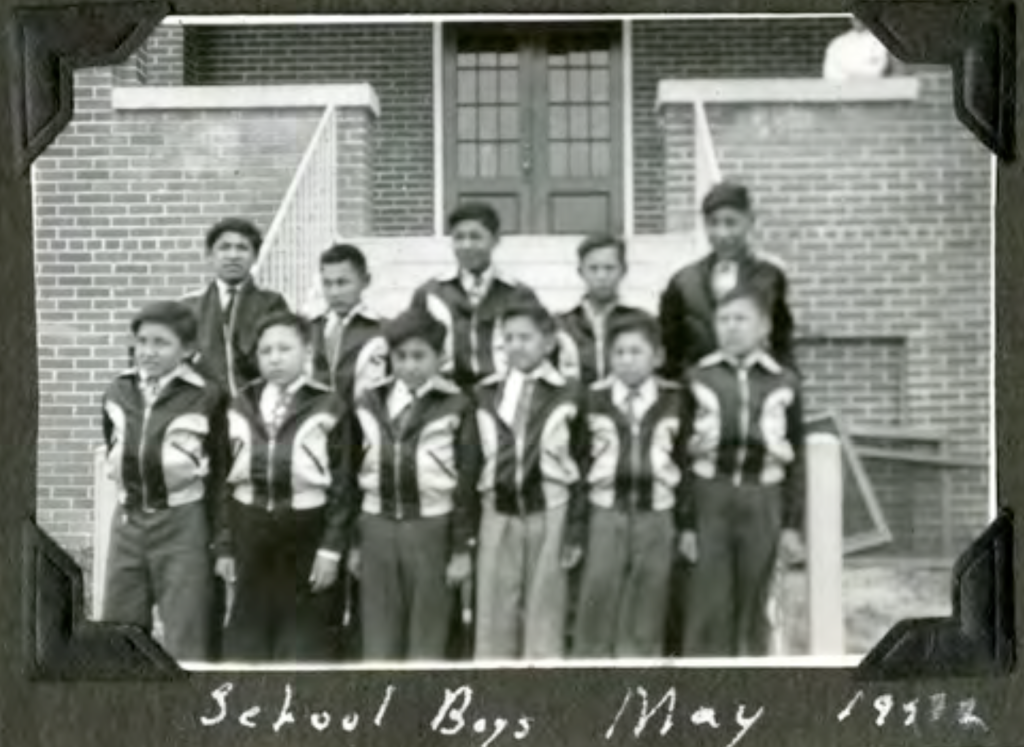 School boys outside on steps of the first floor main entrance. May 1952. Shingwauk Residential Schools Centre, Algoma University.