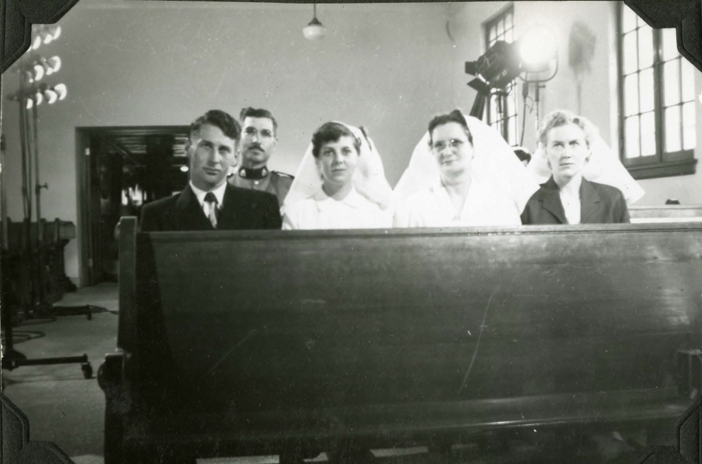 Staff in chapel during filming of a movie. 1952. Shingwauk Residential Schools Centre, Algoma University.