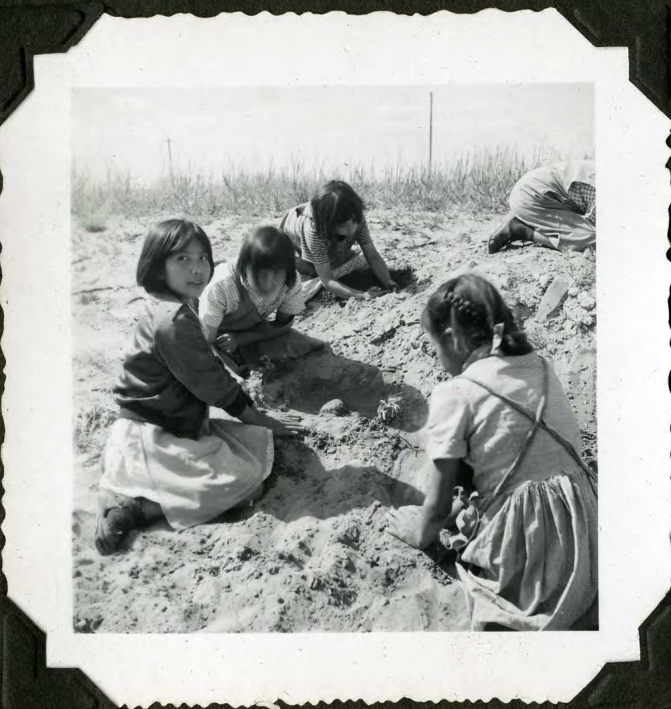 When the weather was nice, students would sometimes be brought by staff for recreational time around the school grounds, like these nearby sand dunes. Early 1950s. Shingwauk Residential Schools Centre, Algoma University.