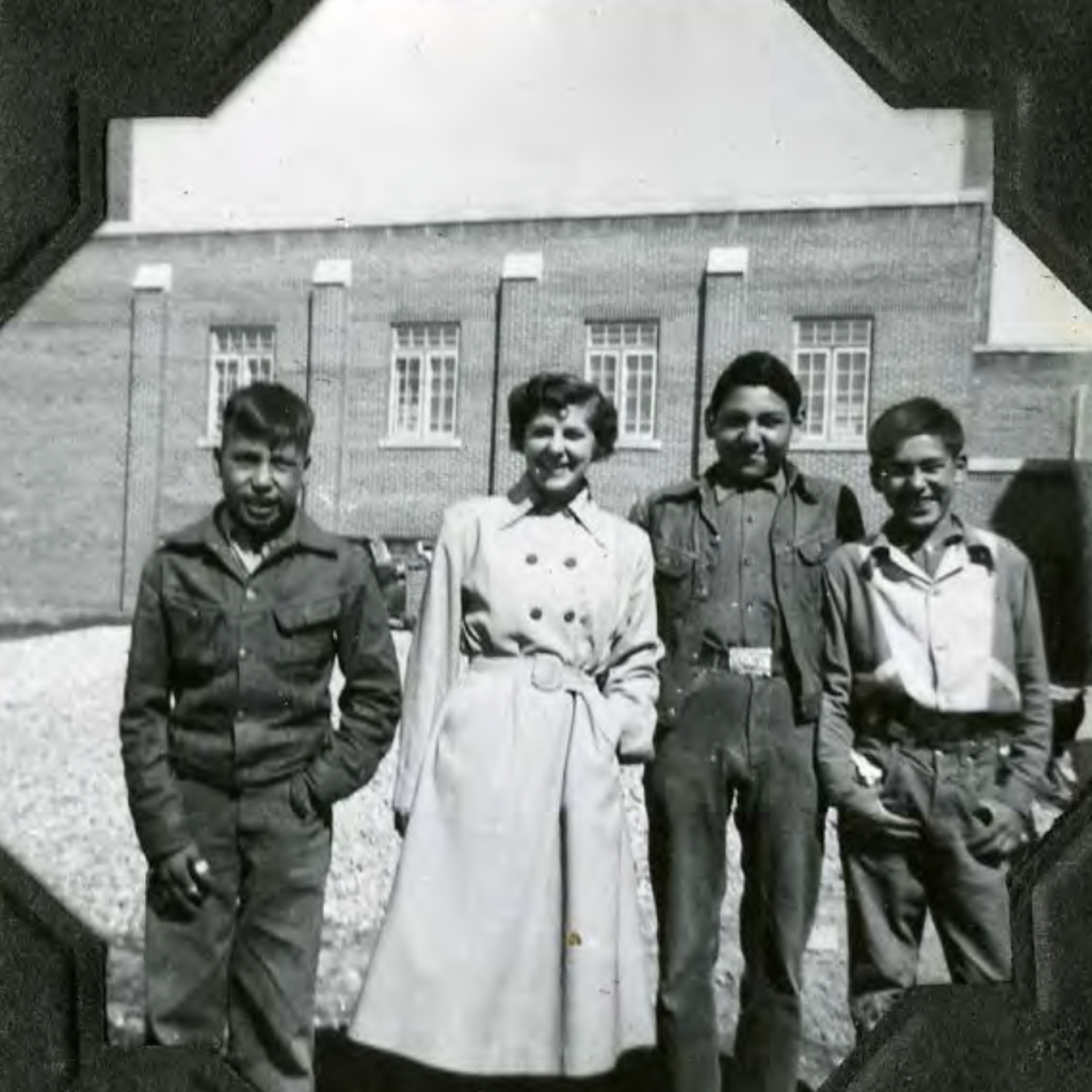 Students outside standing in front of the school chapel. 1950s. Shingwauk Residential Schools Centre, Algoma University