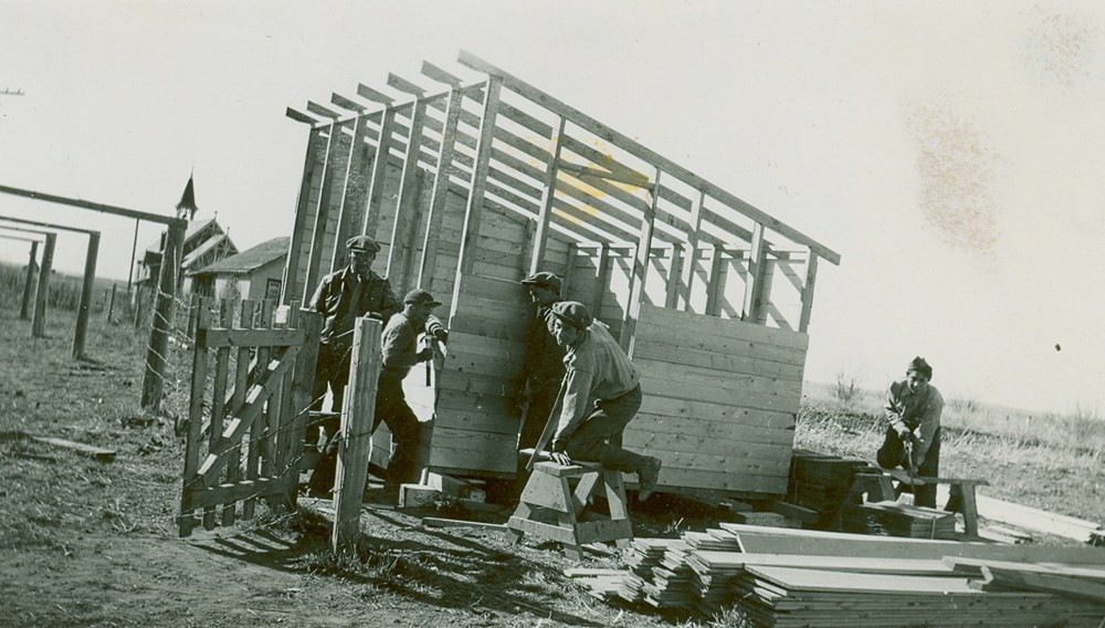 Students spent much of their time doing maintenance and chores for the school. Here, workshop boys build a brooder house. [194-?]. P75-103-S7-187 from the General Synod Archives, Anglican Church of Canada.