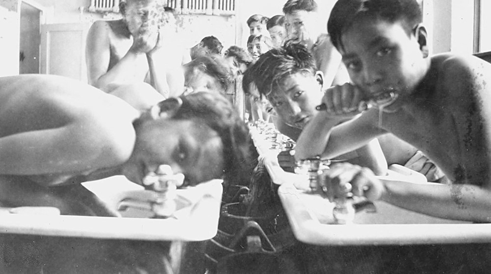 Old Sun Residential School, Gleichen, Alta. - Wash up time for boys. - [194-?]. P75-103-S7-203 from The General Synod Archives, Anglican Church of Canada