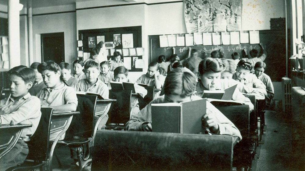 Grades 4 and 5 classroom with students working at their desks- [194-?]. P75-103-S7-205 from The General Synod Archives, Anglican Church of Canada