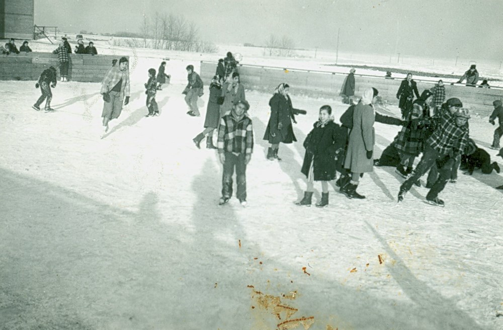 Old Sun School, Gleichen, Alberta - Children skating. - [ca. 1945]. P7538-1008 from The General Synod Archives, Anglican Church of Canada