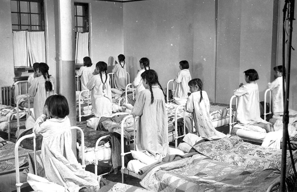 Girls praying on their beds - 1952. P8471-11 from The General Synod Archives, Anglican Church of Canada