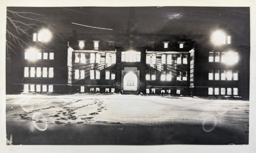 The Edmonton IRS main school building photographed at night with snow out front, 1936. PR1985.0100 from The Provincial Archives of Alberta, Open Copyright.