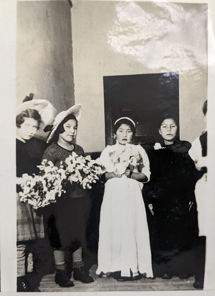 Students dressed to act out a wedding, likely taken in the dining room or playroom within the basement of the main school building between 1926-1937. PR1985.0100 from The Provincial Archives of Alberta, Open Copyright.