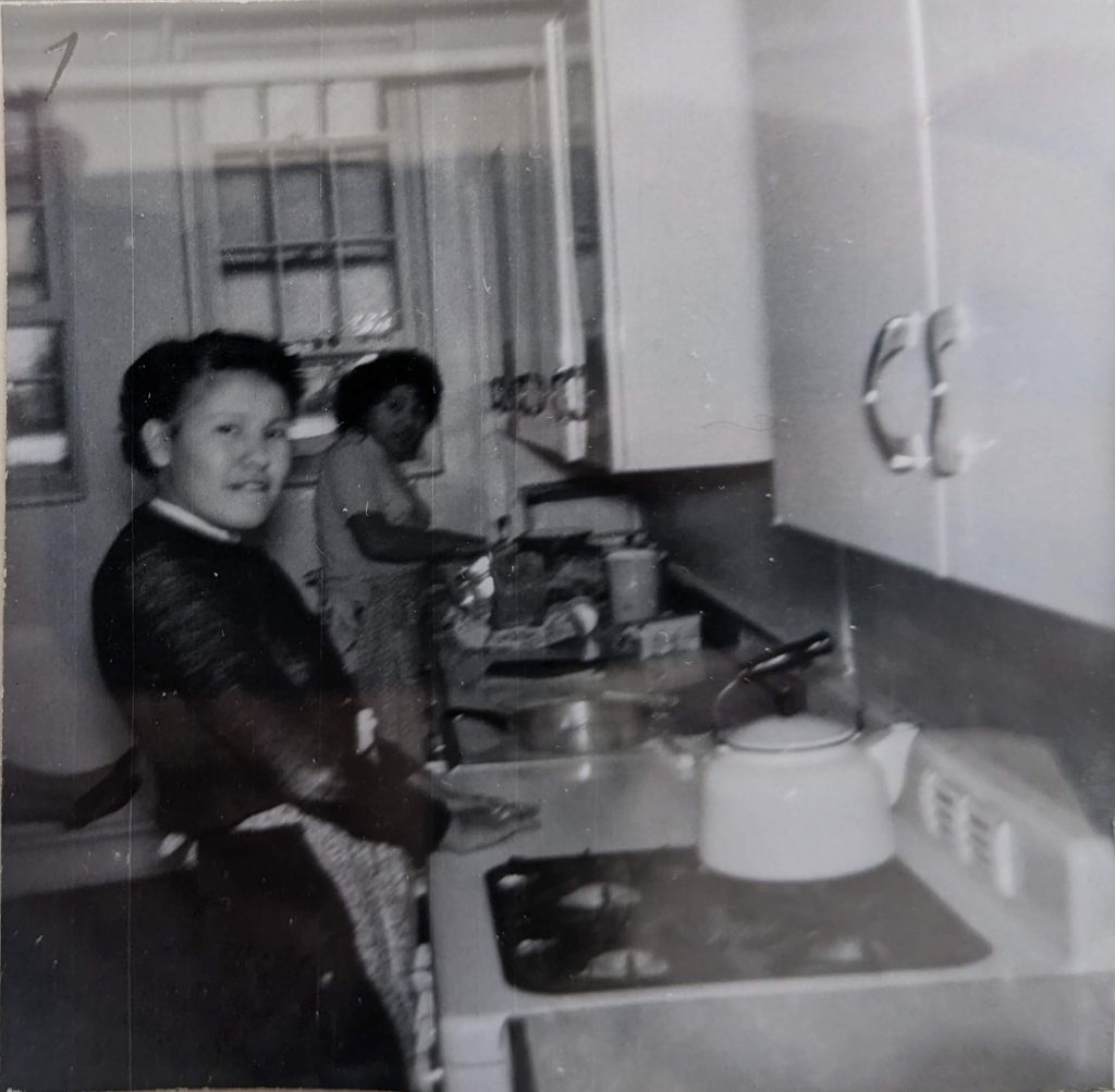 Students working in the kitchen in the basement of the main school building, between 1926-1937. PR1985.0100 from The Provincial Archives of Alberta, Open Copyright.