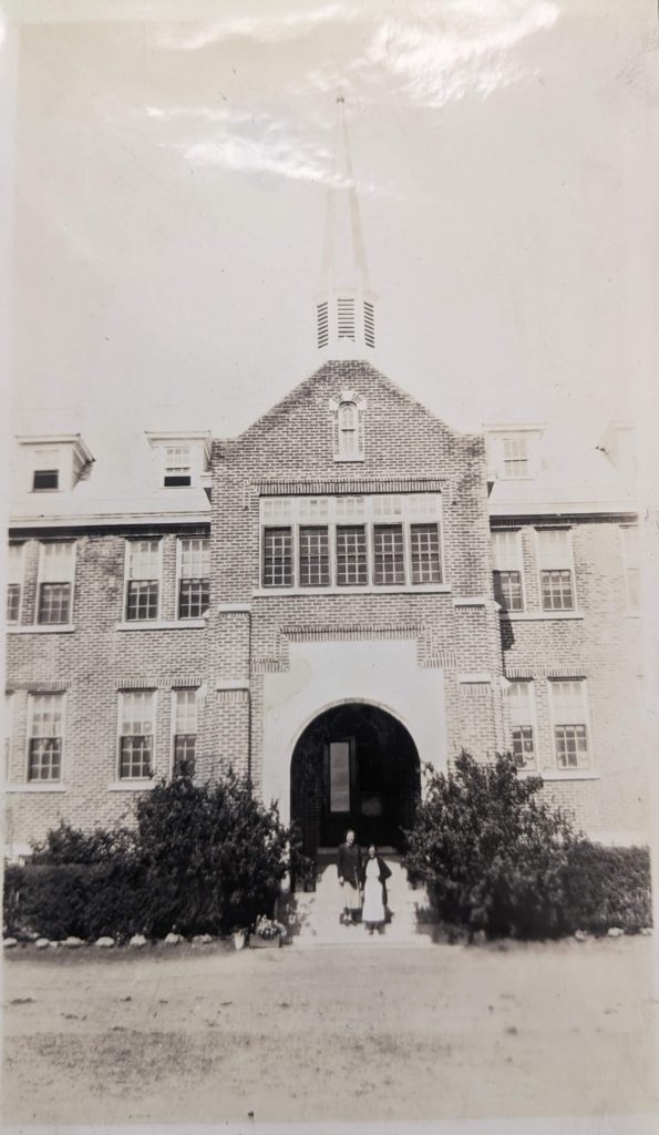 Jean and Phyllis stand in the entrance to the Edmonton IRS, 1936. PR1985.0100 from The Provincial Archives of Alberta, Open Copyright.