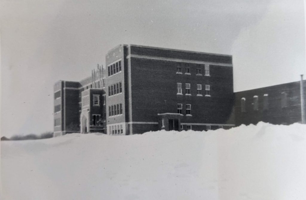 The exterior of Blue Quills showing two-level gym extension on the right hand side of photo, between 1947-1951. PR1973.0248/864 from The Provincial Archives of Alberta, Open Copyright.