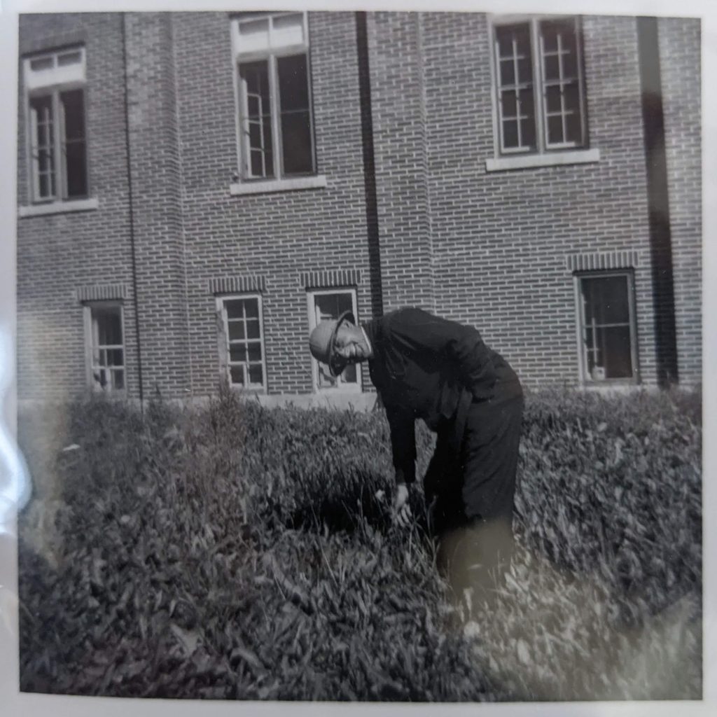 Father Rollande posing outside of the Blue Quills school, likely in 1950. PR1973.0248/287 from The Provincial Archives of Alberta, Open Copyright.