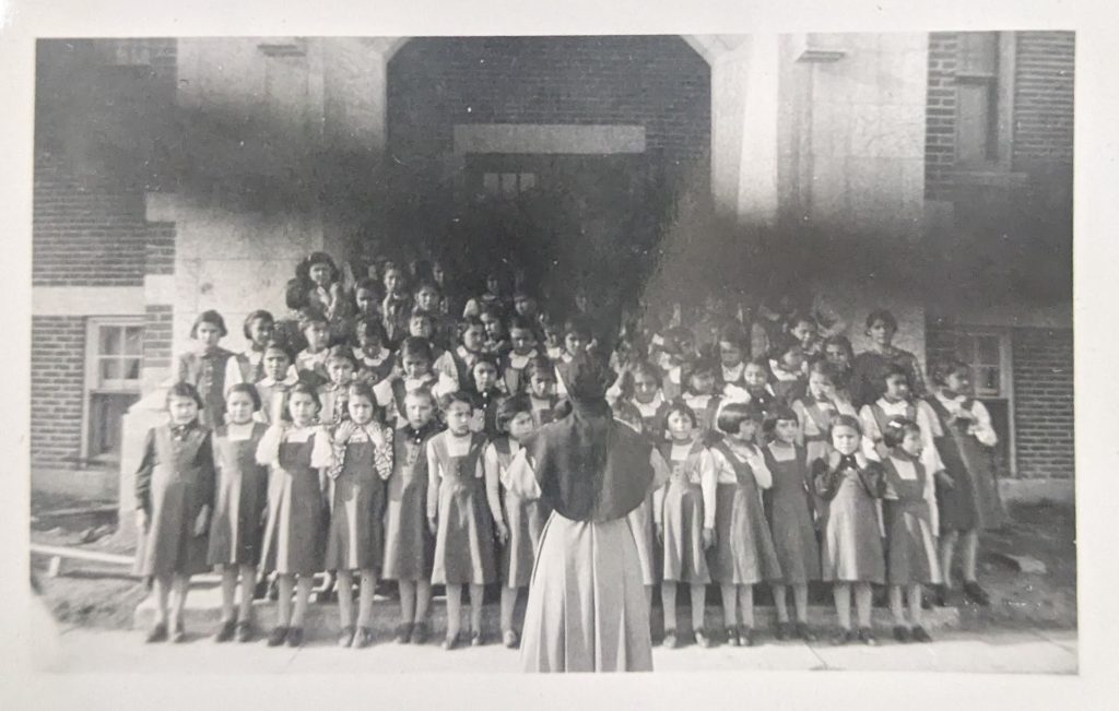 Girls on the front steps of Blue Quills, between 1948-1951. PR1973.0248/864 from The Provincial Archives of Alberta, Open Copyright.