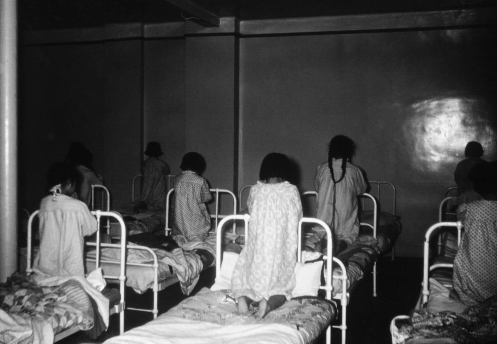 Bedtime prayers in the girls' dormitory, Old Sun School. 1955-1957. NA-4817-22. Courtesy of Glenbow Archives .