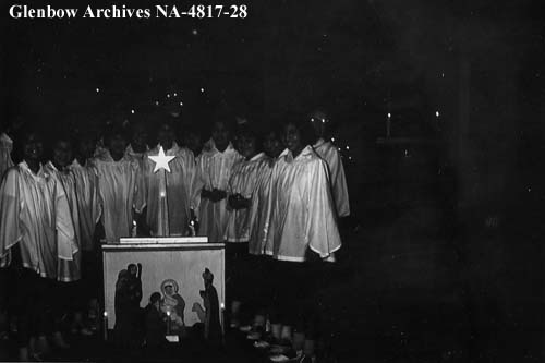 Choir at Christmas, Old Sun School. Nativity scene in foreground. Possibly in the chapel. 1955-1957. NA-4817-28. Courtesy of Glenbow Archives .