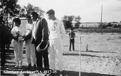 Levi Many Heads, sports champion, and group receiving shield/plaque on Sports Day. 1955-1957. NA-4817-35. Courtesy of Glenbow Archives.