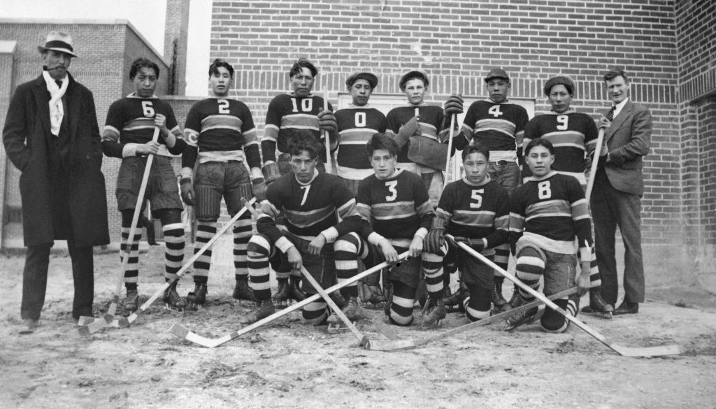 Old Sun hockey team, 1935-1938. Standing outside the boys' playroom. NA-5452-11. Courtesy of Glenbow Archives .